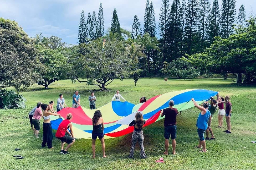 Kalani work-trade crew participating in parachute team building activity_resize